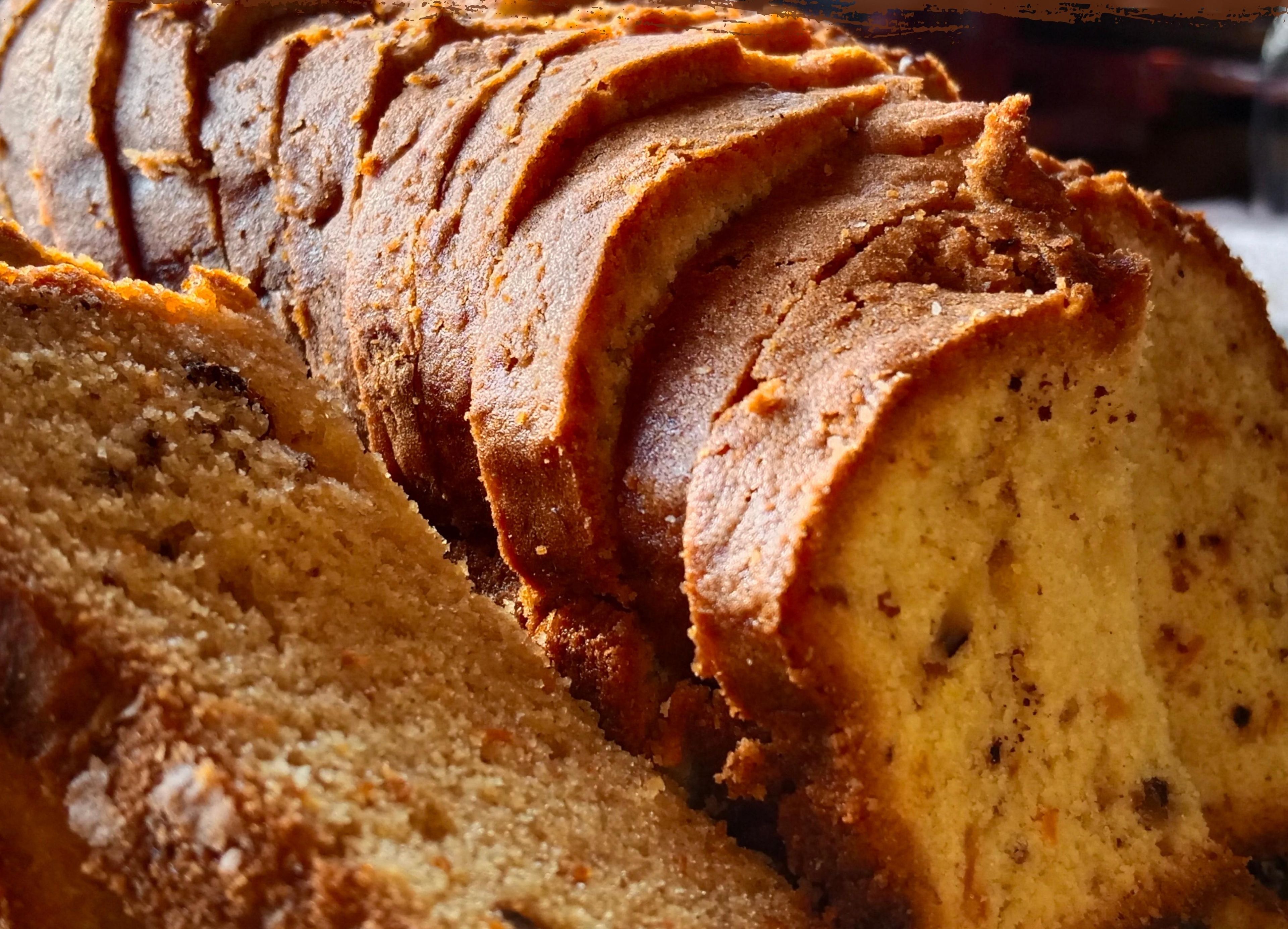 A loaf of bread with a crusty exterior, sliced and arranged in a fan shape.