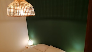 A bed with white bedding, two bedside lamps, and a hanging lamp above. - Bright and comfortable, it offers a wonderful view from the sea-facing terrace.  (Viareggio)