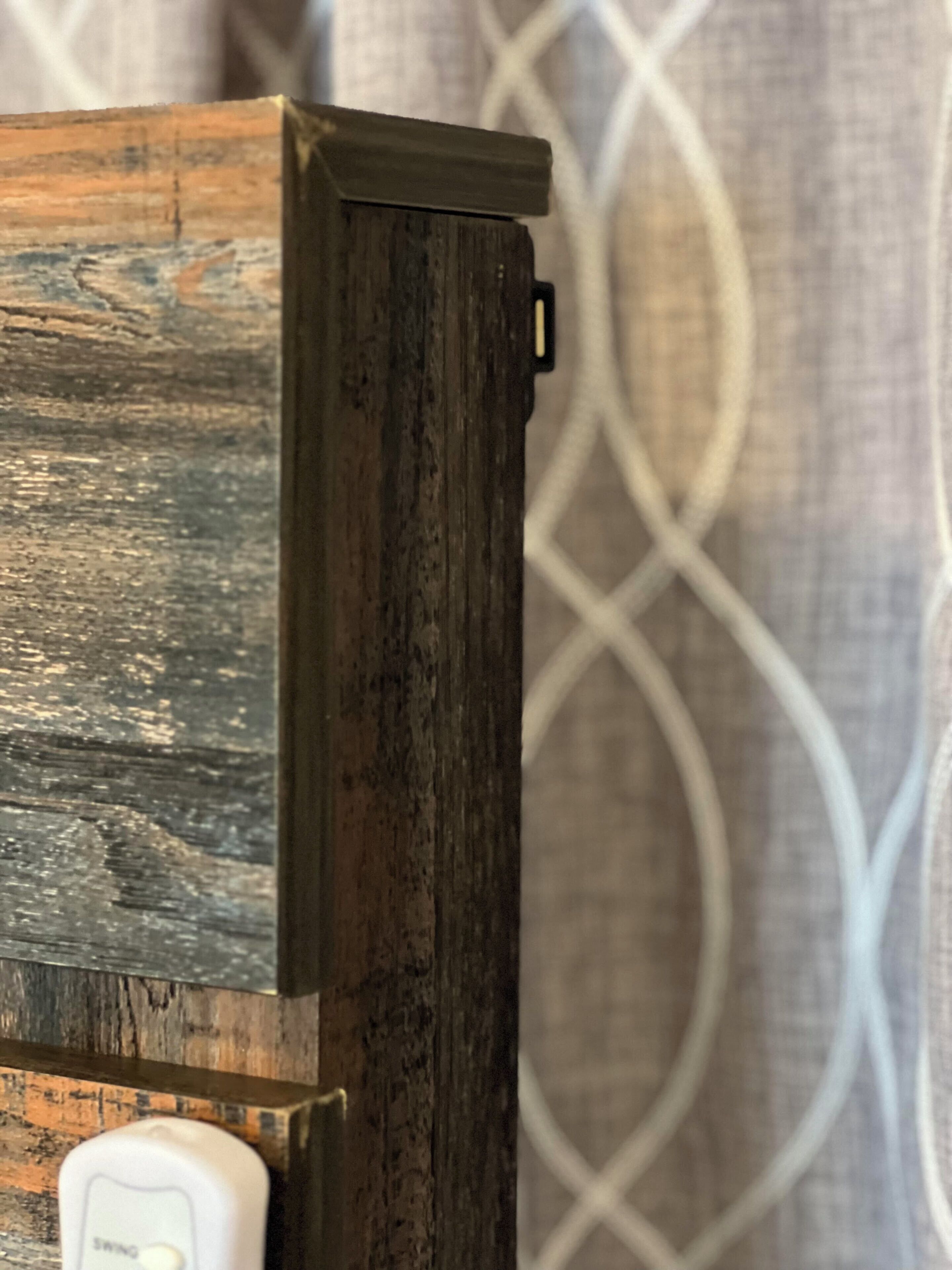 A wooden piece of furniture with a white switch labeled "SWING".