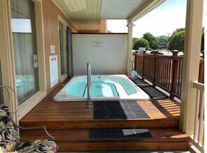 Relax in a hot tub surrounded by a wooden deck.