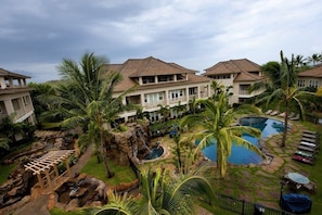 A resort with multiple buildings, a swimming pool, and a waterfall feature. - 3BR I Luxury in Paradise l Beaches, Golf, Shopping (Koloa)