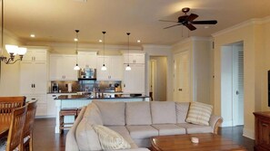 A modern kitchen with white cabinets, pendant lighting, and a ceiling fan. - 3BR I Poolside Lanai Villa l Parking, Sunset View (Koloa)