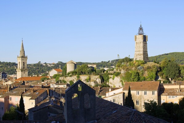 A historic town with a prominent church tower and a large bell tower.