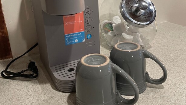 A Keurig coffee maker with two gray mugs on a countertop. - Dakota Suite in Downtown Fargo Historic Building   Pet Friendly (Fargo)