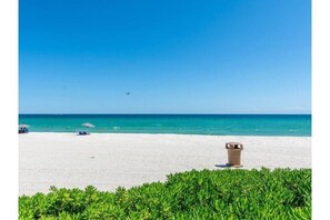 Enjoy a serene beach experience with access to calm turquoise waters and lush green surroundings.