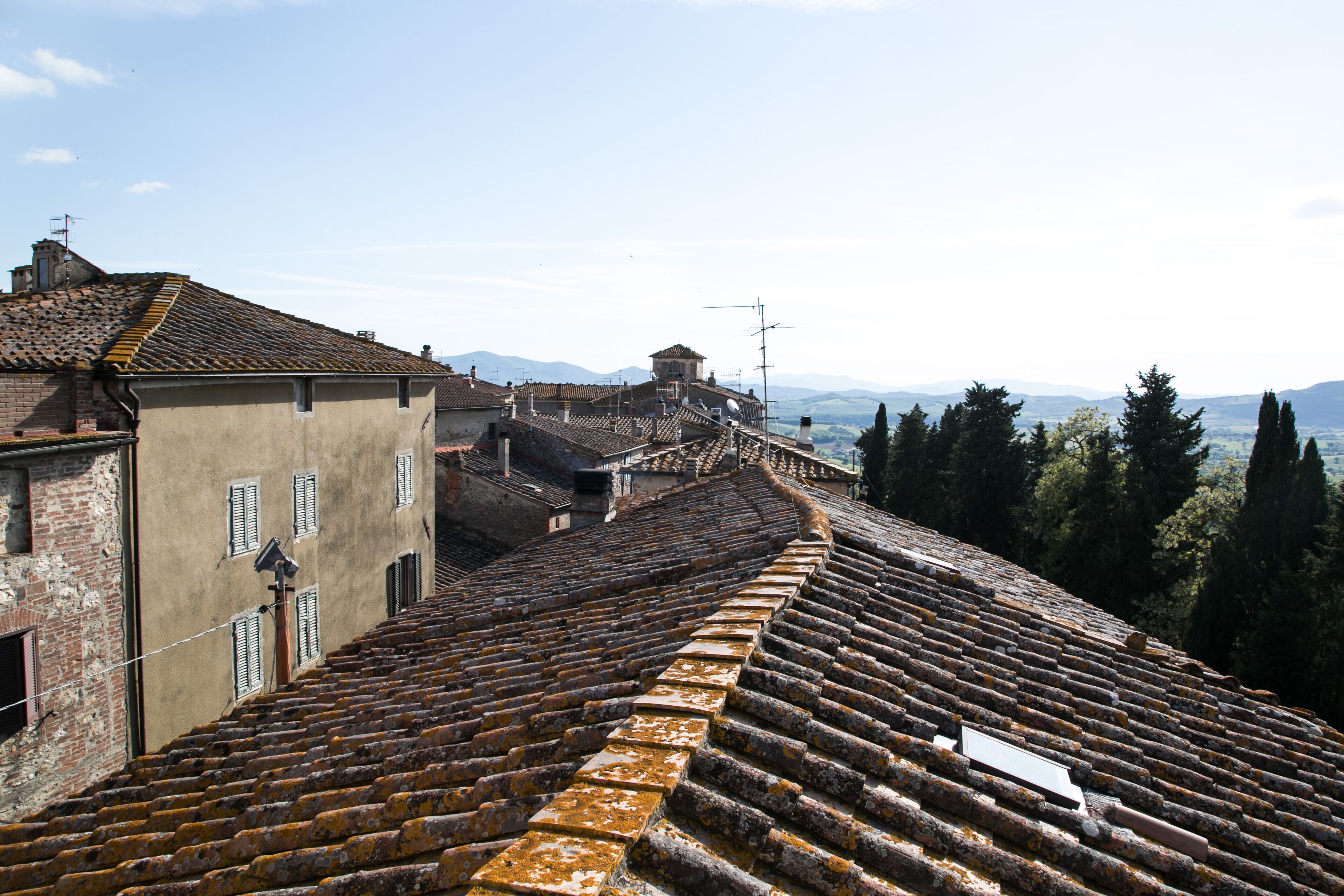 A terraced building with a steep staircase leading up to a rooftop terrace.