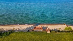 A beach with a sandy shore and a clear view of the ocean. - Sheridan Shores Escape - Hot Tub w Amazing Views! (Lexington Township)