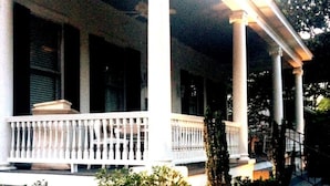 A porch with white columns and a balustrade.