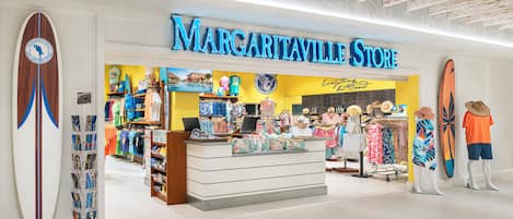 A store named 'Margaville Store' with a surfboard display and various clothing items.
