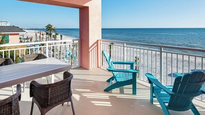 A balcony with a view of the beach, wicker chairs, a table, and a railing. - Margaritaville Beach Resort Fort Myers  (Fort Myers Beach)