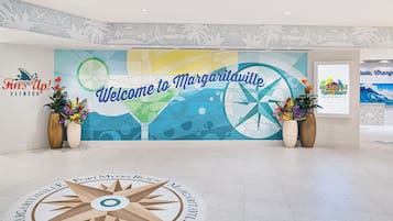 A welcome sign for Margateville with a nautical theme, including a compass rose and palm trees.