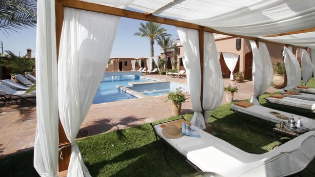 A poolside area with white canopies, sun loungers, and a small pool. - Villa Tata Marie Marrakech (Marrakech-Safi)