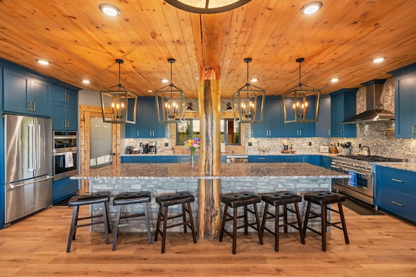 A chef's kitchen is fully equipped with high-end appliances and three ovens.