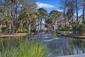 Guests can stroll across the serene pond to reach this tranquil retreat.