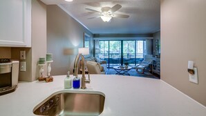 A kitchen with a stainless steel sink, a ceiling fan, and recessed lighting. - Serene Myrtle Beach Condo w/ Resort Amenities! (Myrtle Beach)