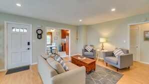 A living room with a sofa, armchairs, a coffee table, and a rug. - Charming Canandaigua Lake House w/ Deck & Views! (Canandaigua)