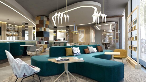 Un espace de détente moderne avec un canapé de couleur turquoise, un bar et un coin salon équipé d’un téléviseur.
