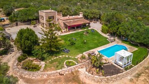A villa with a swimming pool, a covered patio, and a well-maintained lawn. - Sa Caseta by Interhome (Ses Salines)