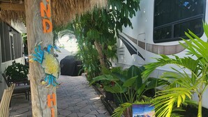 A thatched roof structure with a sign reading "Island Hideaway." - Key Largo Relaxing Getaway (Key Largo)