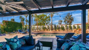 A covered outdoor area with a pool, lounge chairs, and a pergola. - 10 Bd/walk 2 shuttle 4 Stagecoach/Ask-Deals/Games (La Quinta)