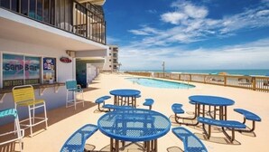 A poolside area with a restaurant named "Sand Bar" and a view of the ocean. - Oceanfront Family Friendly Garden City Beach Condo (Murrells Inlet)