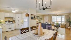 A spacious living area with a dining table, chairs, a sofa, and a kitchen area with cabinets and appliances. - Lake Hamilton Home: 5 Mi to Hot Springs! (Hot Springs)