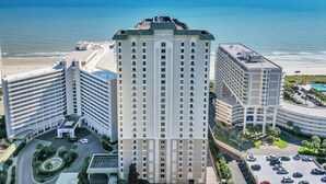 A high-rise hotel with multiple floors, a central courtyard, and a view of the beach and ocean. - Ocean view 3 BR/3BA condo!  Royale Palms 12th floor! Perfect for families! (Myrtle Beach)
