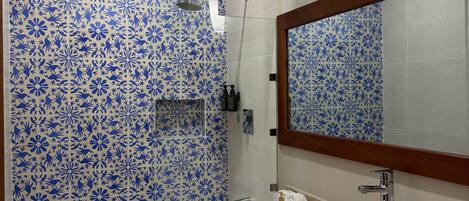 A bathroom with a bathtub, a sink, and a shower.