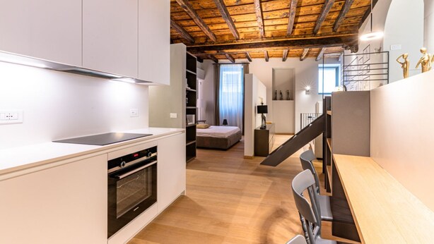 A modern kitchen with white cabinetry, a built-in oven, and a wooden ceiling. - VIA SIMONE MAYR, 2 · Bergamo città Alta - appartamento di charme (Bergamo)