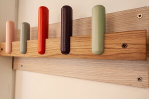 A wooden shelf with cylindrical objects.