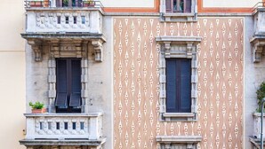 A building with ornate balconies and patterned facade. - Paganini boutique apartment (Milano)