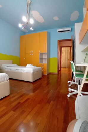 A room with a bed, a desk, and a wardrobe.