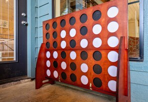 A wooden panel with circular cutouts, mounted on a door frame. - Secluded Hot Tub Retreat for Families and Friends (Broken Bow)