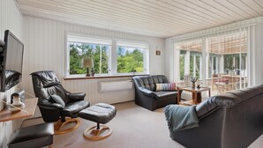 A spacious living room with a large window, a fireplace, and a comfortable seating area. - Lovely home in Hemmet with WiFi (Hemmet)
