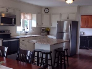 Enjoy meals in the kitchen with a dining area and modern appliances.
