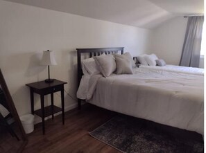 Relax in a serene space with a large bed, bedside tables, and soft lighting.