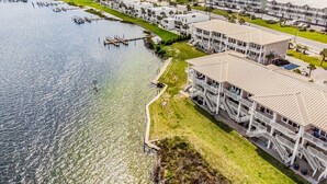 An aerial view of a coastal hotel with multiple buildings, a marina, and a beach in the background. - SunnySide Up ~ Beach & Bay!! (Pensacola Beach)