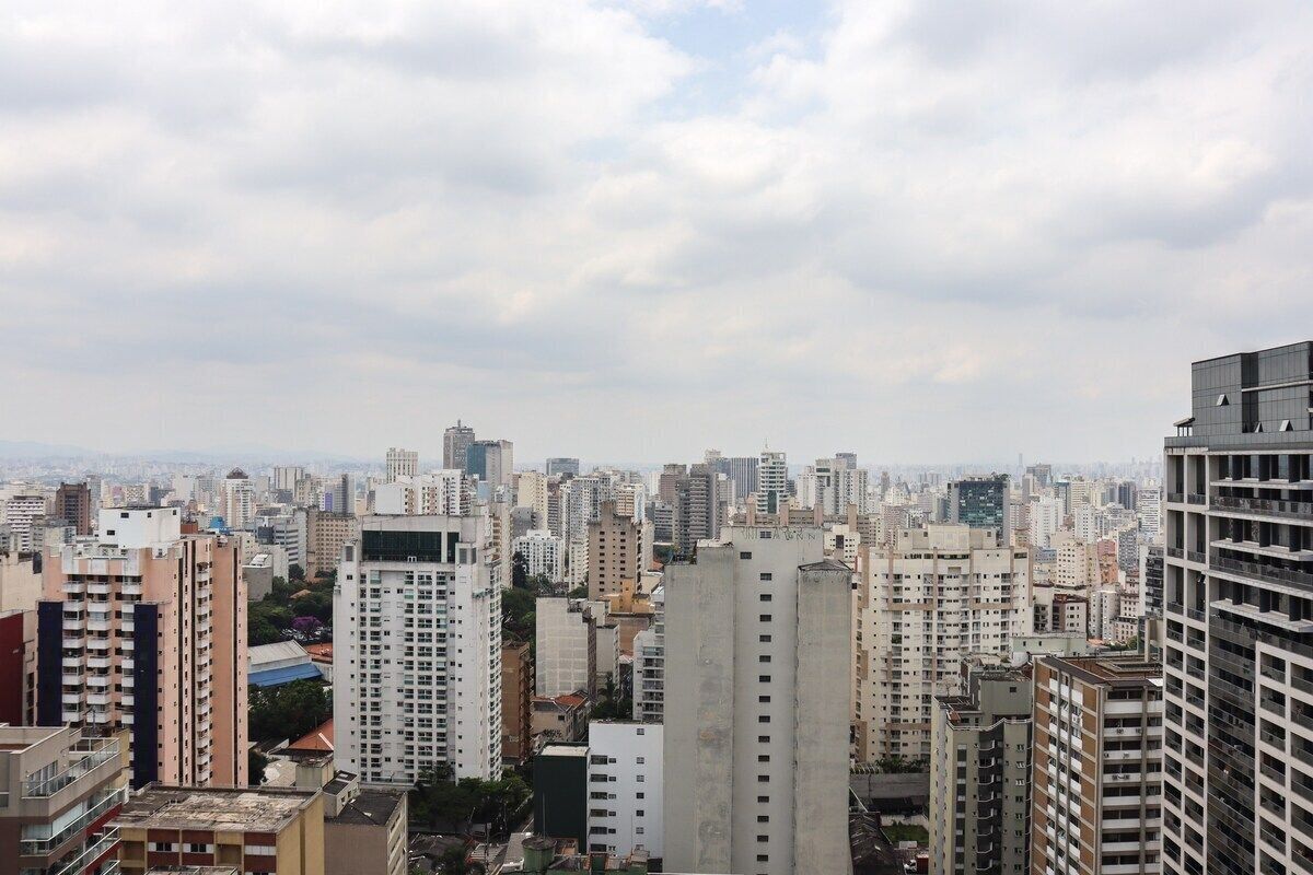 A high-rise urban area with dense buildings and a cloudy sky.
