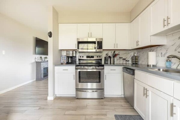 Enjoy cooking in this well-equipped kitchen with a microwave, oven, and dishwasher.
