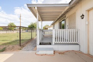 Welcome to a cozy home with a covered porch and steps leading to the entrance.
