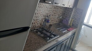 A kitchen with a refrigerator, stove, and cabinets. - Apartment in Marrakesh  (Marrakech)