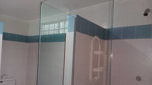 A bathroom with a glass shower enclosure, a toilet, and a bidet. - Habitacion Extragrande Cerca al Parque Venezuela (Barranquilla)