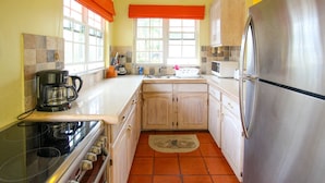 A compact kitchen with a stove, coffee maker, and a refrigerator. - Amazing pool and nearby beach - Bliss (Sunset Crest)