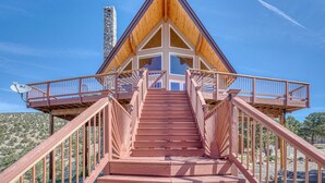 A wooden staircase leading to a building with a triangular roof and a stone chimney. - Mountain Views• Private Hot Tub•Large Deck (Salida)