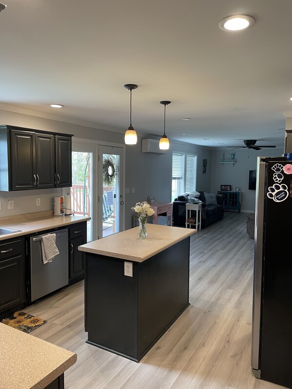 Enjoy cooking in this well-lit kitchen with a central island and sink.