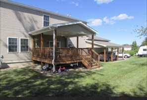 Enjoy a peaceful retreat on this single-story home's covered porch with a staircase leading to the main house.