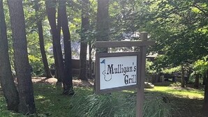 A sign for Mulligan's Grill in a wooded area. - Peaceful Retreat in Hidden Valley, PA: Ski Resort, Golf and Trails in Mountain (Somerset)