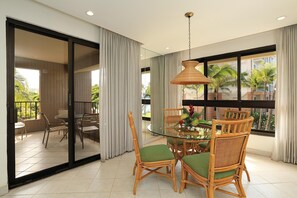 Enjoy meals in this stylish dining area with a round table and comfortable wicker chairs.
