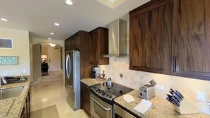 Enjoy cooking in this well-equipped kitchen with a refrigerator, oven, stove, and toaster.