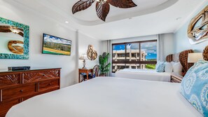 Relax in comfort with a large bed, a dresser with carvings, and a TV above, offering a view of the surrounding area.